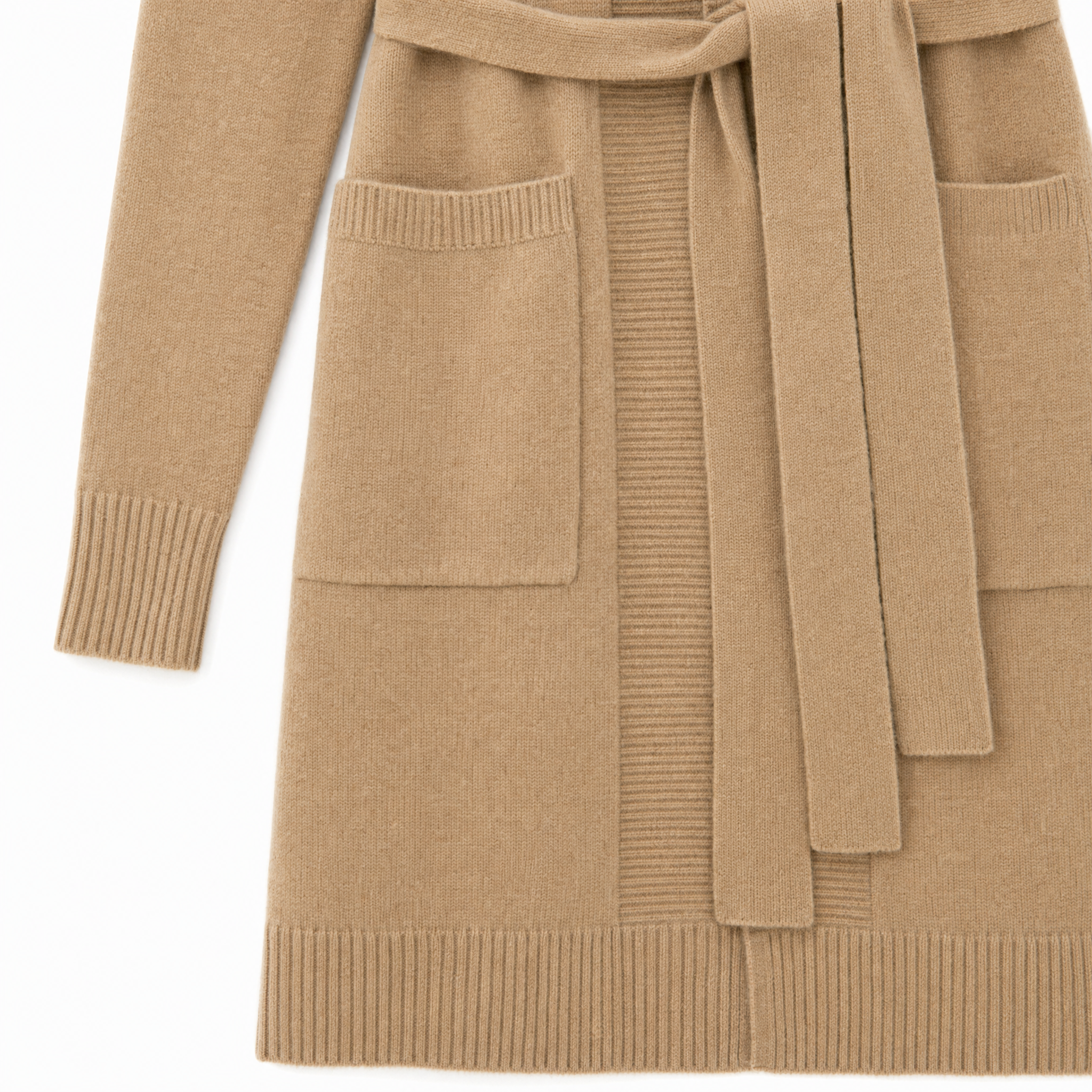 A close-up of a camel-colored knit cardigan with a matching tie belt, featuring two front patch pockets and ribbed cuffs and hem, shown on a plain white background.