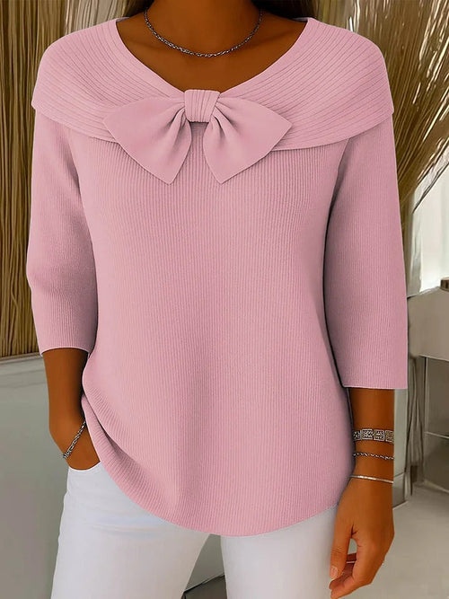 Neeko Pink bow-detail knit sweater with a wide folded neckline, ribbed texture, three-quarter sleeves, and a relaxed silhouette